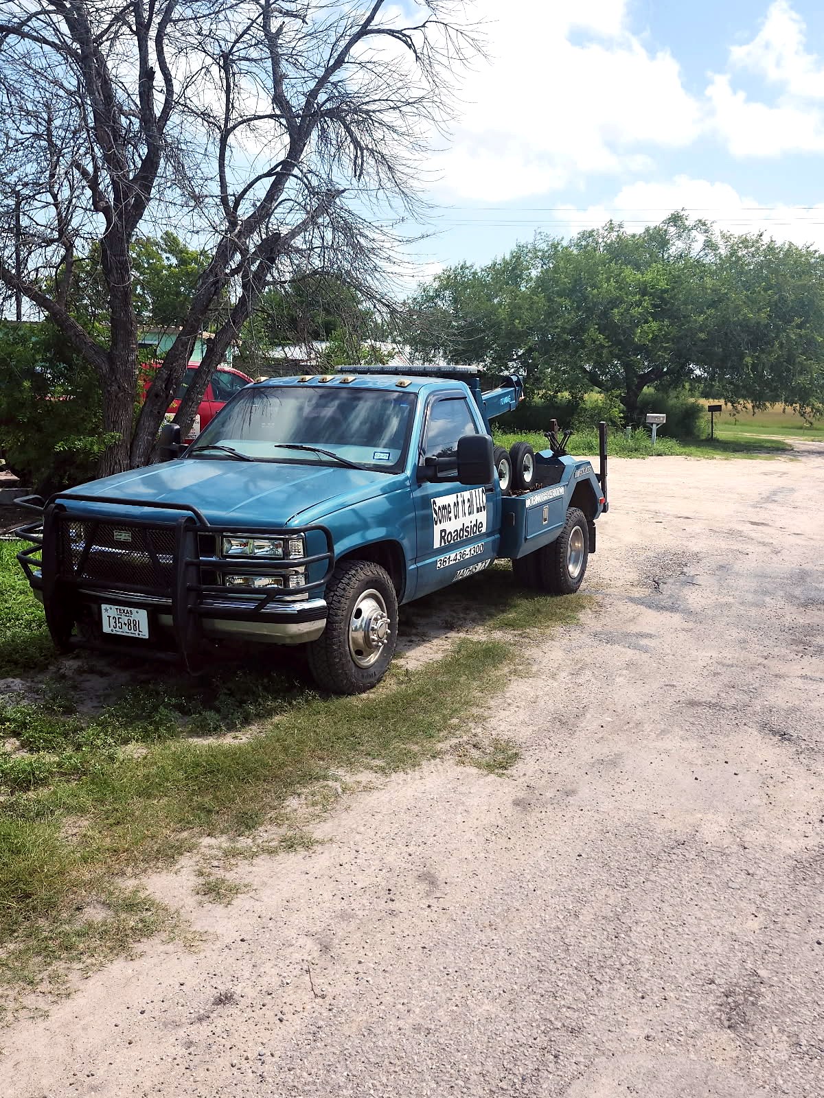 Some Of It All blue wheel-lift tow truck for towing and roadside assistance